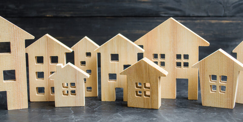 Simple wooden houses sit in a row.